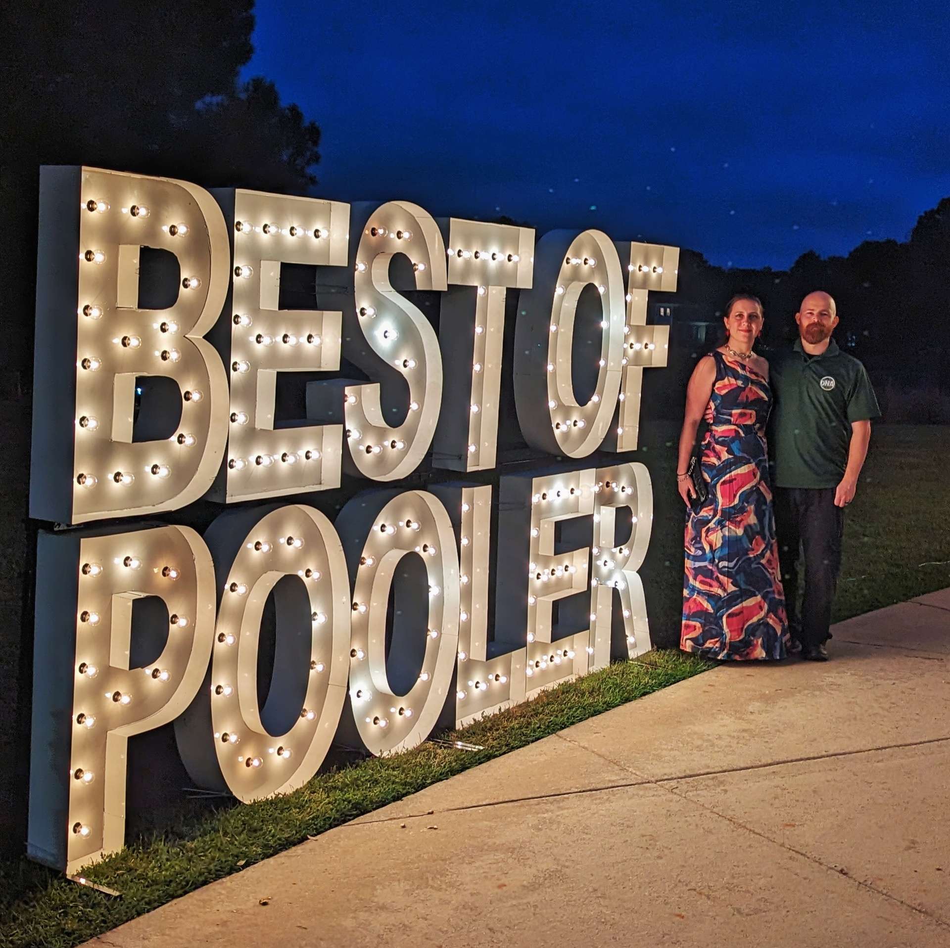 David and Camille beside the Best of Pooler display